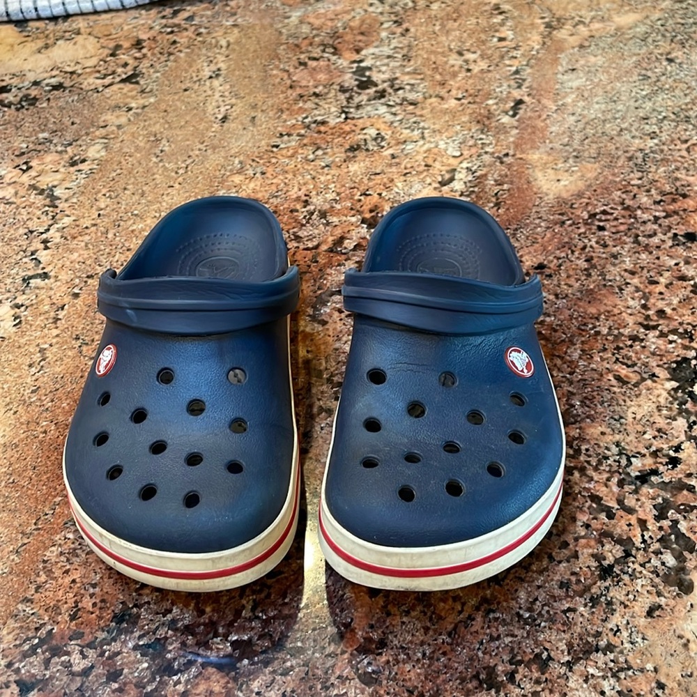 Navy Crocs with white and Red edging W7. M5. J5